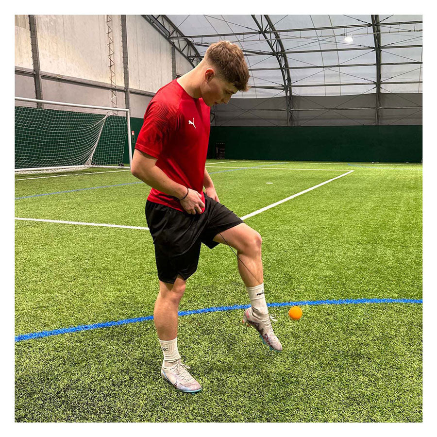 Spectron Smart Ball Kick Tracker som håller upp